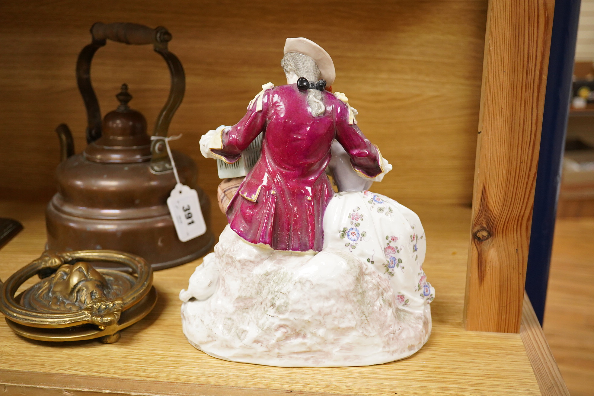 A German porcelain group of two figures with a bird cage and dog, 24cm high (Restored)